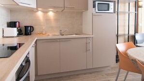 A modern kitchen with beige cabinetry, a microwave, a coffee maker, and a toaster. - Renovated 3-room duplex at the foot of the slopes with WiFi in Tignes (Tignes)