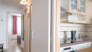 A modern kitchen with a built-in oven, a coffee maker, and a sink. - South/West Apt 2R, 500m from slopes, Wi-Fi, Val-Claret (Tignes)
