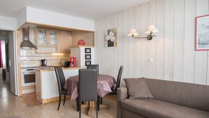 A compact living space with a kitchenette, dining area, and a sofa. - South/West Apt 2R, 500m from slopes, Wi-Fi, Val-Claret (Tignes)
