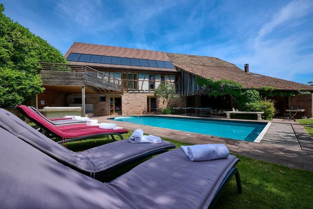A poolside area with lounge chairs and a swimming pool.