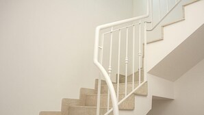 A staircase with white railings and beige steps. - Marilu B&B (Matino)