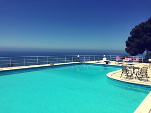 Seasonal outdoor pool, open 10 AM to 8 PM, pool umbrellas, pool loungers