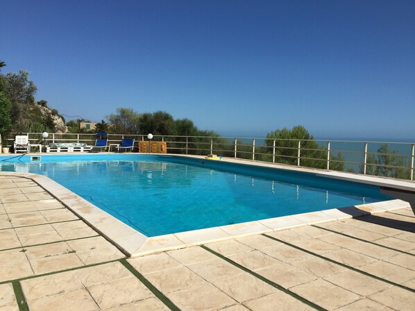 Seasonal outdoor pool, open 10 AM to 8 PM, pool umbrellas, pool loungers