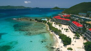 A coastal hotel with a beach, clear waters, and boats. - Sapphire Beachfront Renovated Villa 1200 SF! - Free Wi-Fi, Generator (St Thomas)