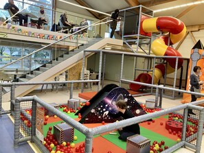 A multi-level indoor play area with a slide, ball pit, and climbing structures. - Large Sweden house in the holiday park Mirow (Mirow, OT Granzow)