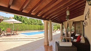 A covered outdoor area with a pool, seating, and a view of the landscape. - Es Pou - Charming villa with pool in Biniamar, Selva, Mallorca (Selva)