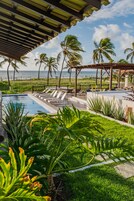 Una piscina al aire libre, sillones reclinables de piscina