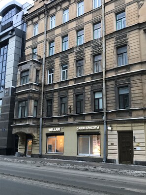Classic building with ornate detailing and symmetrical facade, featuring two storefronts on the ground floor.