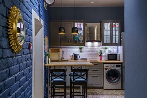 Enjoy casual dining or working in this kitchen with microwave, washing machine, and ample counter space.