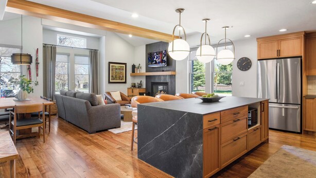 A modern kitchen with a central island, wooden cabinets, stainless steel appliances, and pendant lighting. - The Moose Lodge - New 2BR, Walk to PCMR / Main St! (Park City)