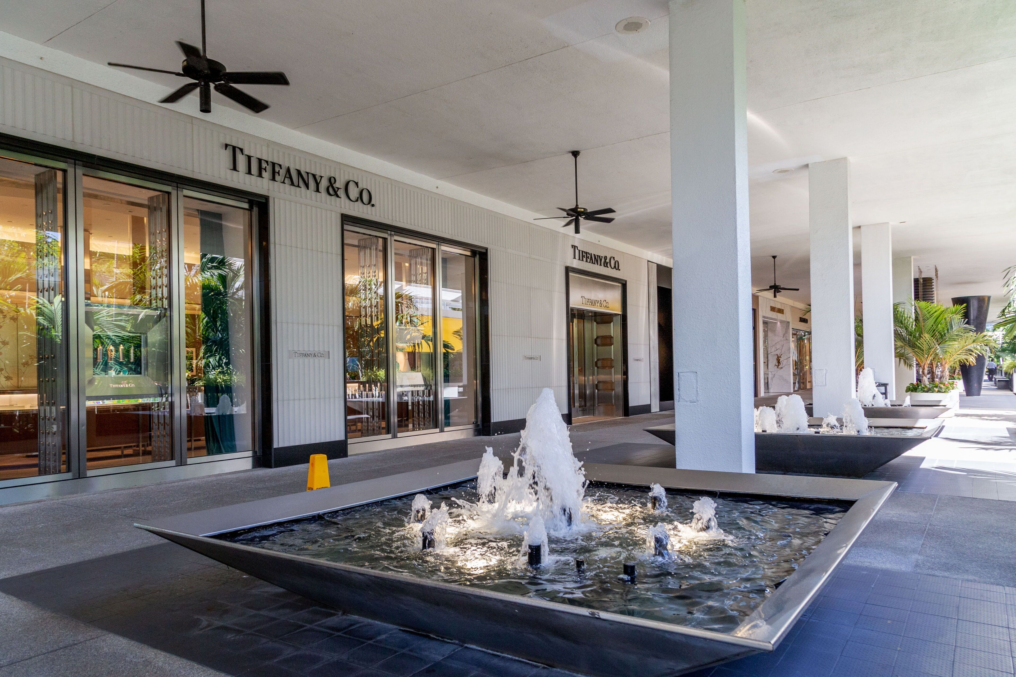 A Tiffany & Co. store with a water feature in front.