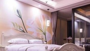 A bedroom with a white bed, wooden headboard, and a wall mural. - Diyuan Boutique Garden Hotel (Shanghai)