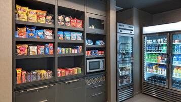 A snack and beverage section with various packaged snacks and a microwave.