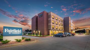 A Fairfield by Marriott hotel with a prominent sign, multiple parking spaces, and a well-lit entrance.