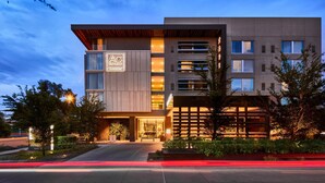 A modern hotel with a prominent AC logo, multiple floors, and a well-lit entrance. - AC Hotel by Marriott Phoenix Biltmore (Phoenix)