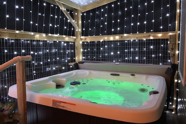 covered and screened in hot tub on lower back deck