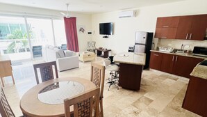 A modern apartment with a dining area, kitchen, and living room. - Modern 1 BR + Pool. Heart of Downtown (Isla Mujeres)