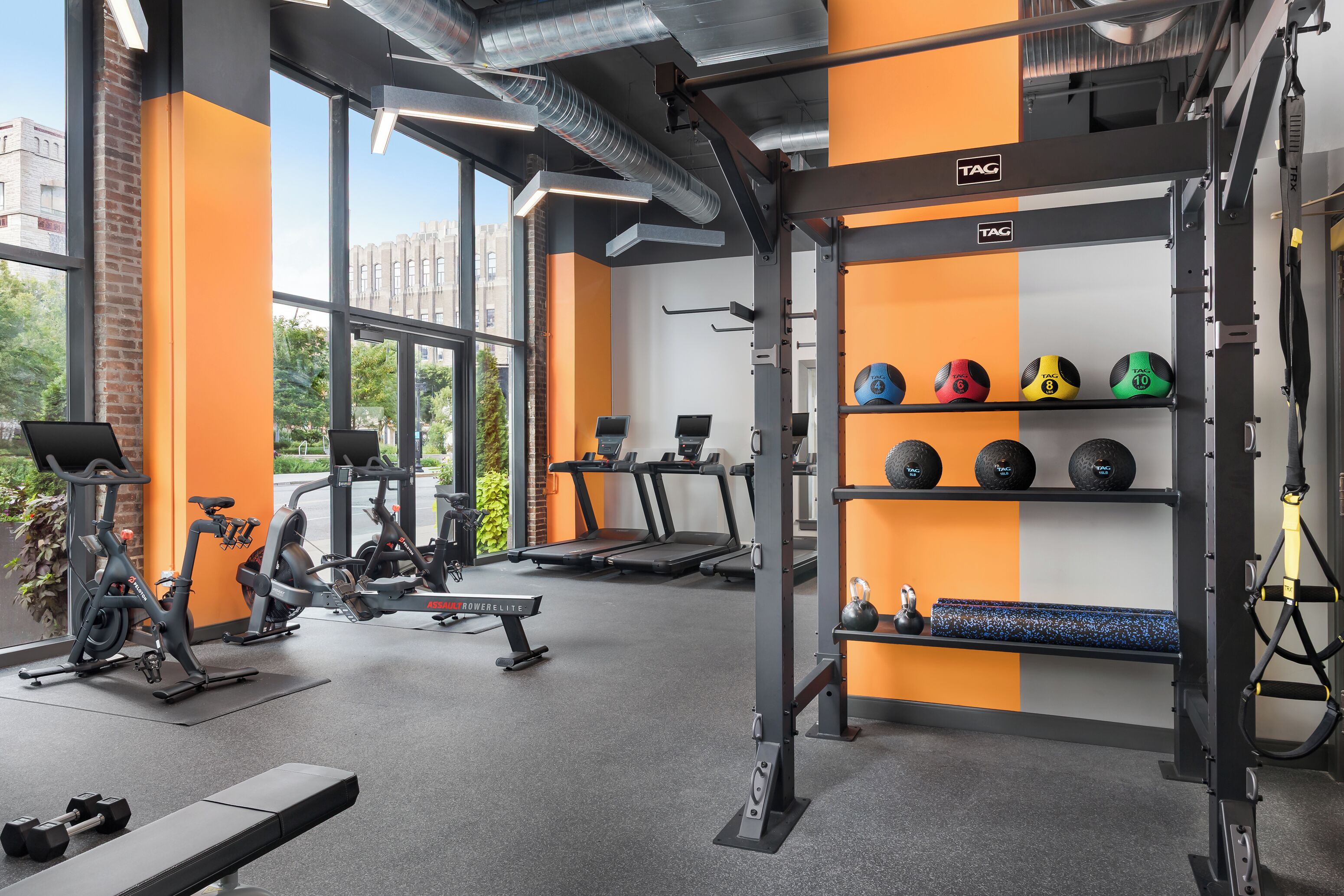 A gym with exercise equipment, treadmills, and weightlifting stations.
