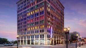 A multi-story hotel with a classic architectural style, featuring a prominent entrance and a large sign indicating it is a hotel. - Angad Arts Hotel St. Louis, Tapestry Collection by Hilton (St. Louis)