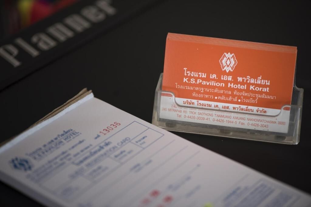 A business card for K.S. Pavilion Hotel Korat with contact details.