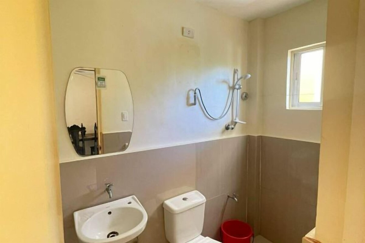 A bathroom with a sink, toilet, and shower.
