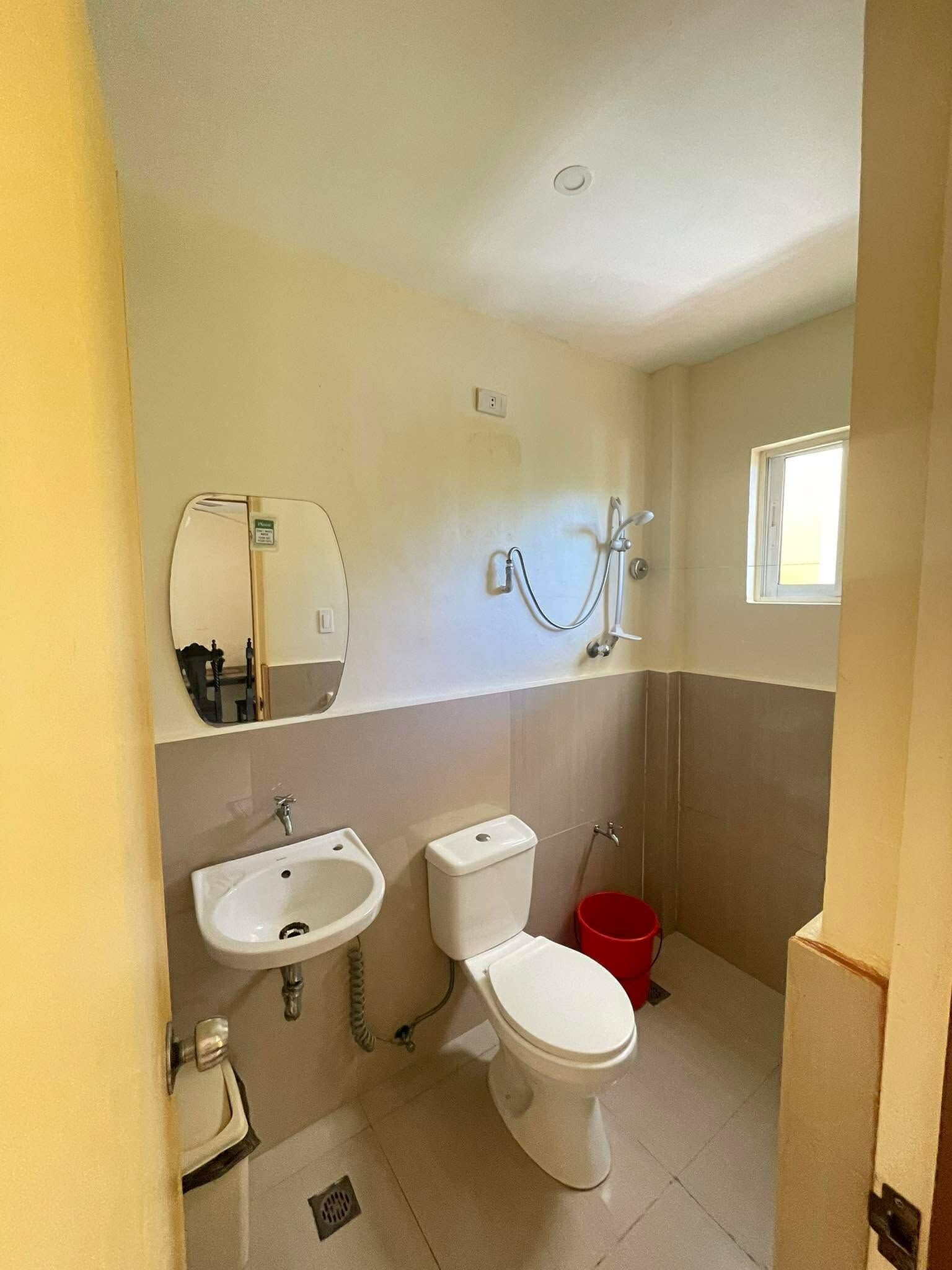 A bathroom with a toilet, sink, and shower.