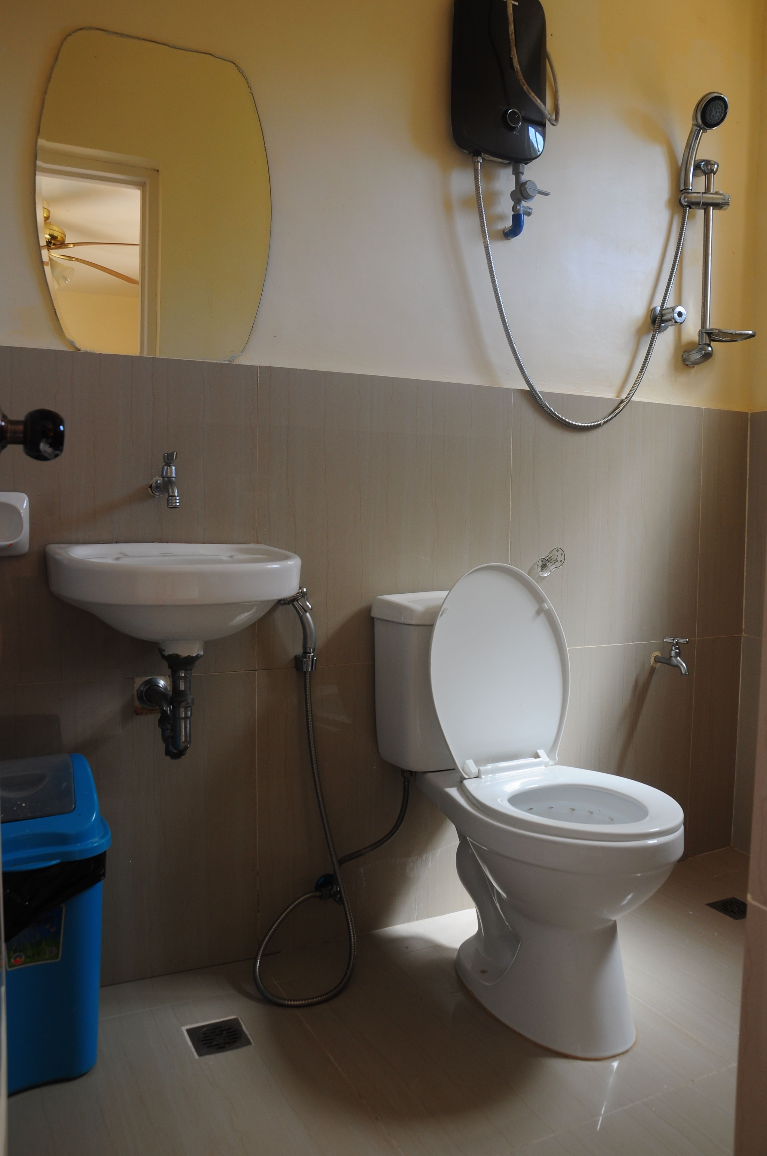A bathroom with a white sink, toilet, and shower.