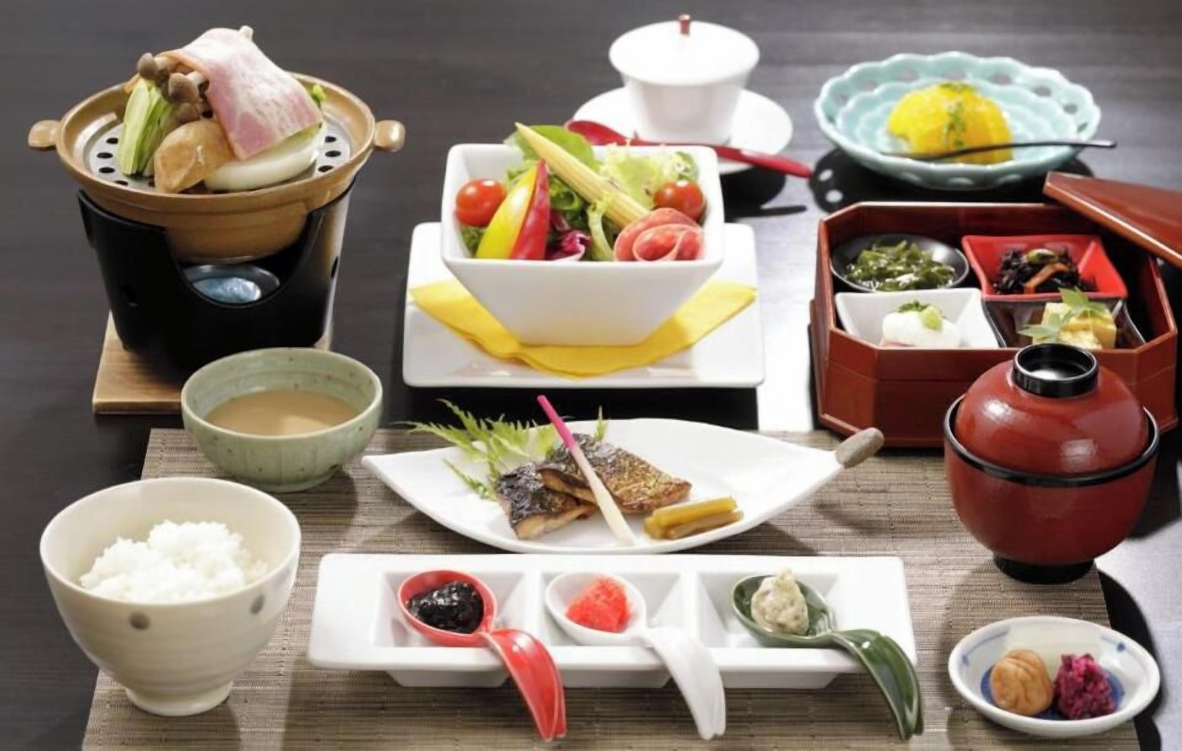 A traditional Japanese meal setup with various dishes and utensils.