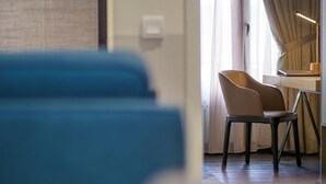 A hotel room with a desk, chair, and a view of the outside through a window. - Bahari Parade Hotel Managed By The Ascott Limited (George Town)