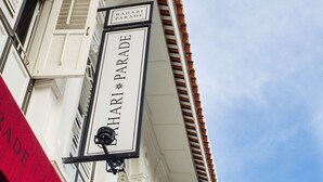 A building with a Bahari Parade sign. - Bahari Parade Hotel Managed By The Ascott Limited (George Town)