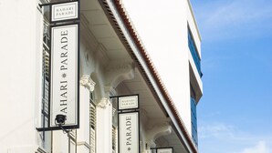A building with multiple signs reading "BAHARI PARADE" indicating a hotel or establishment. - Bahari Parade Hotel Managed By The Ascott Limited (George Town)