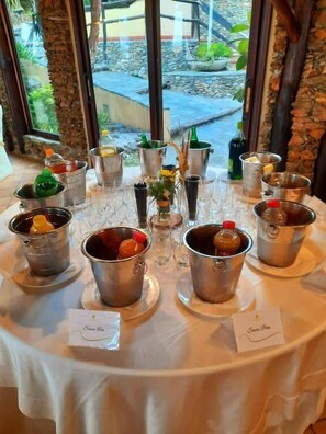 A table set with multiple metal buckets containing various food items, arranged on a white tablecloth. - Borgo della Marinella (Amantea)