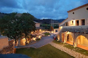 A stone building with a paved pathway leading to a gated entrance. - Borgo della Marinella (Amantea)