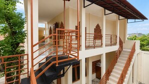 A multi-level building with a staircase, a balcony, and a covered area. - Satya Graha Hotel (Yogyakarta)