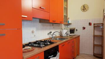 Apartment, 3 Bedrooms | Private kitchen | Full-sized fridge, stovetop, cookware/dishes/utensils
