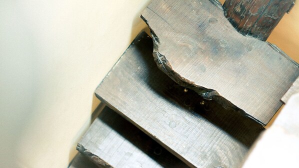 A close-up of a metal object with a rough, unfinished surface, possibly a part of a larger structure or machinery.