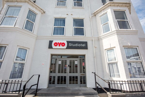 A white building with a sign reading "OYO Studiotel" above the entrance.