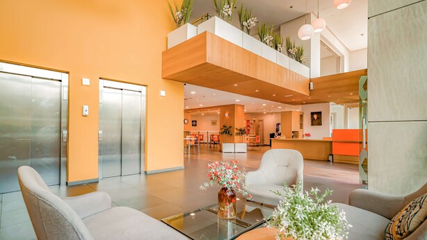 A modern lobby with a glass coffee table, seating area, and an elevator. - Hotel Première Classe Casablanca Centre Ville (Casablanca)