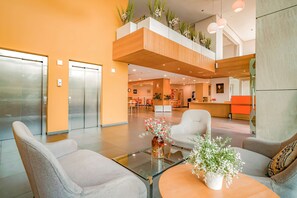 A modern lobby with a glass coffee table, seating area, and an elevator. - Hotel Première Classe Casablanca Centre Ville (Casablanca)
