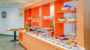 A buffet setup with various food items and a self-service station. - Hotel Première Classe Casablanca Centre Ville (Casablanca)