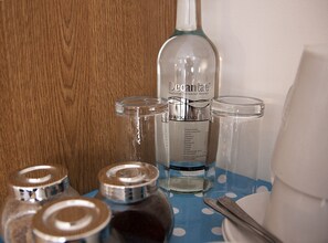 A bottle of Decantae sparkling water with a label detailing mineral content, placed on a table with a blue polka dot tablecloth. - The Dukes (Leighton Buzzard)