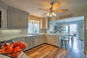 Enjoy cooking in this well-equipped kitchen with a stove, large island, and ample counter space.