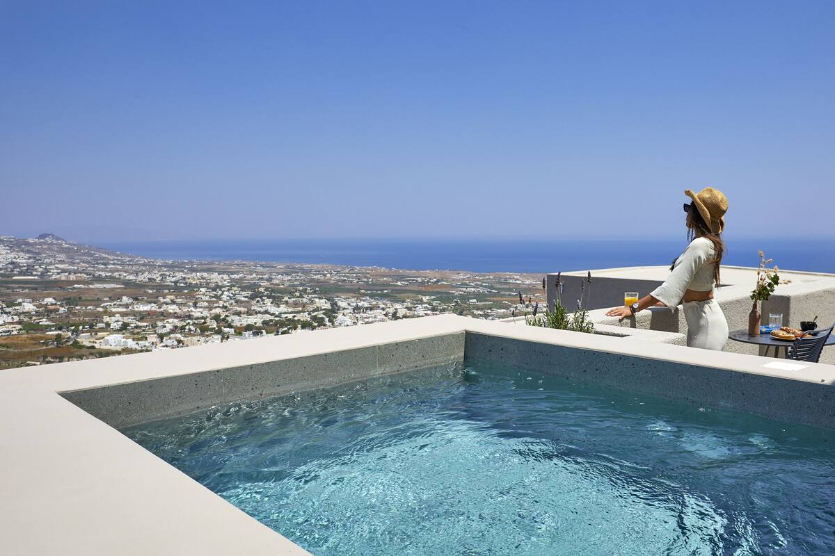 A pool with a view of a coastal town.