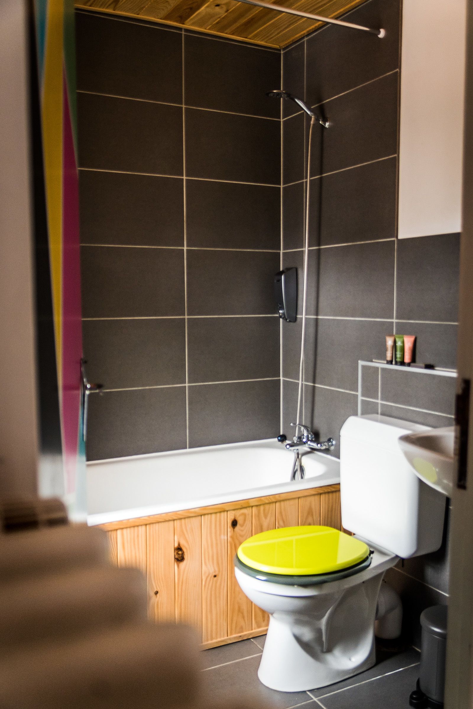 A modern bathroom with a bathtub, toilet, and shower.