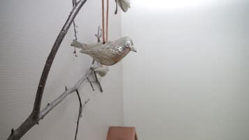 A bird-shaped ornament hanging from a branch.