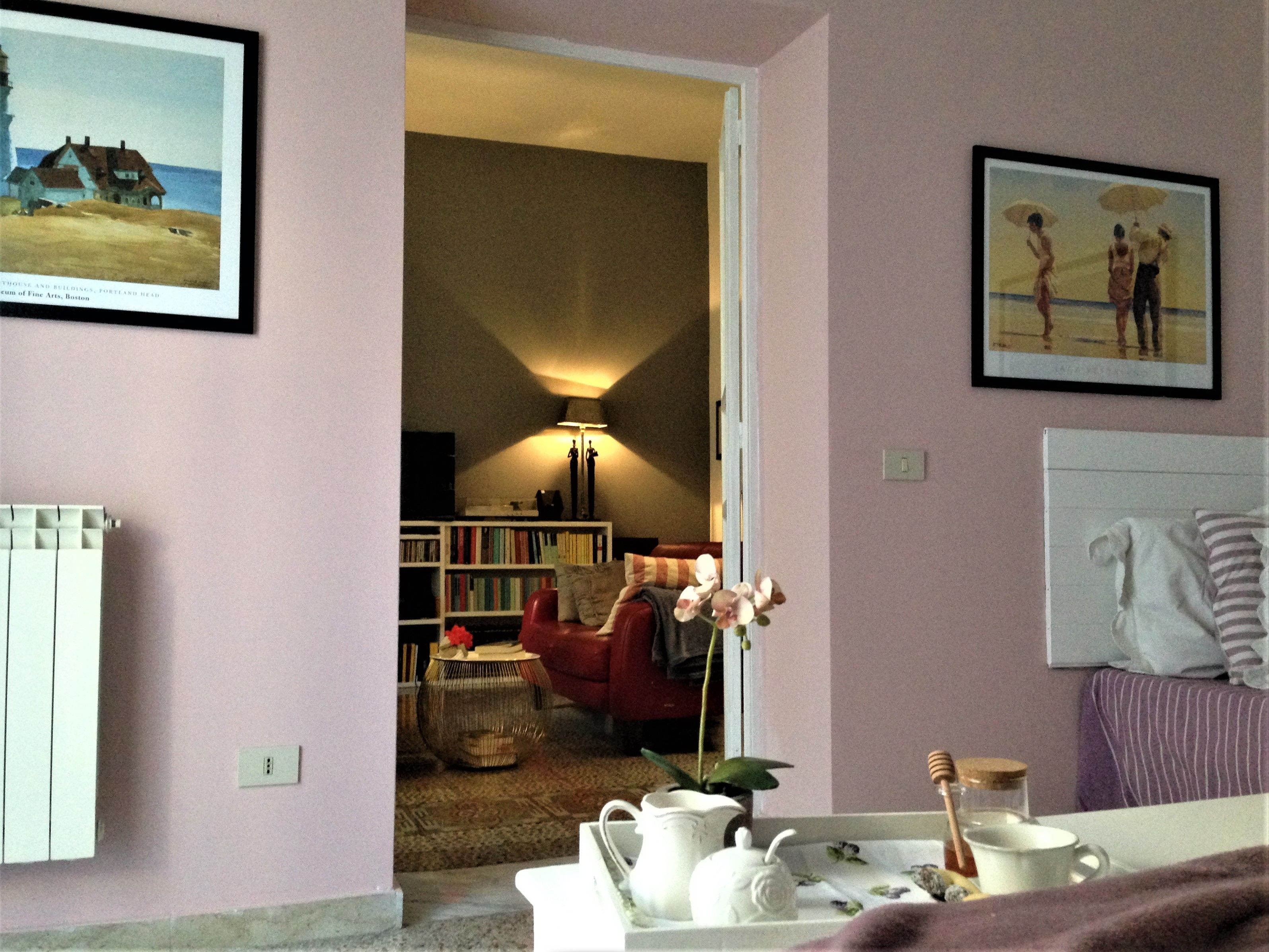 A cozy living room with a fireplace, a bookshelf, and a comfortable seating area.