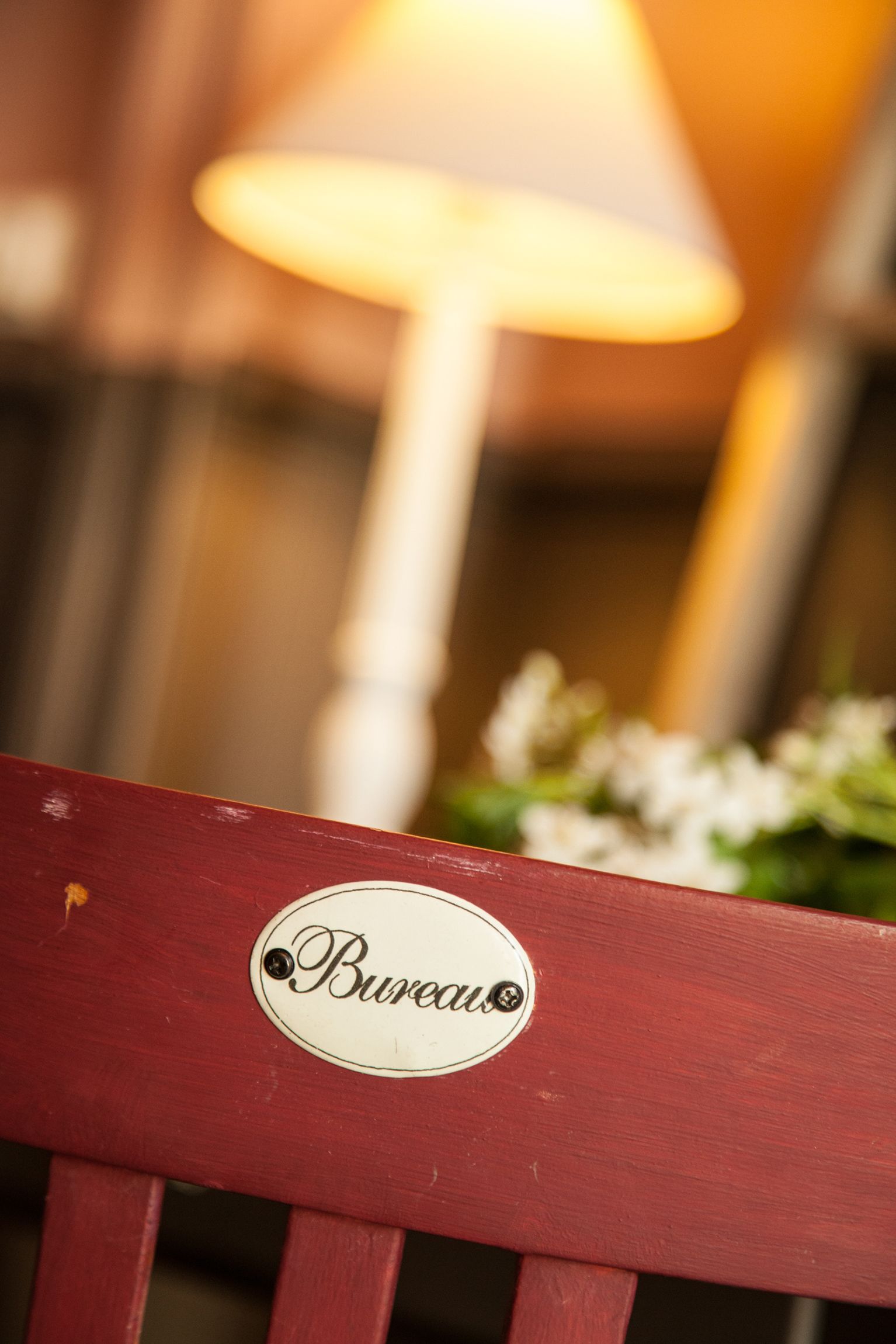 A close-up of a red chair with a "Bureaux" sign.
