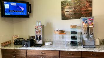 A kitchen counter with a coffee machine, a toaster, a rice cooker, and cereal dispensers.