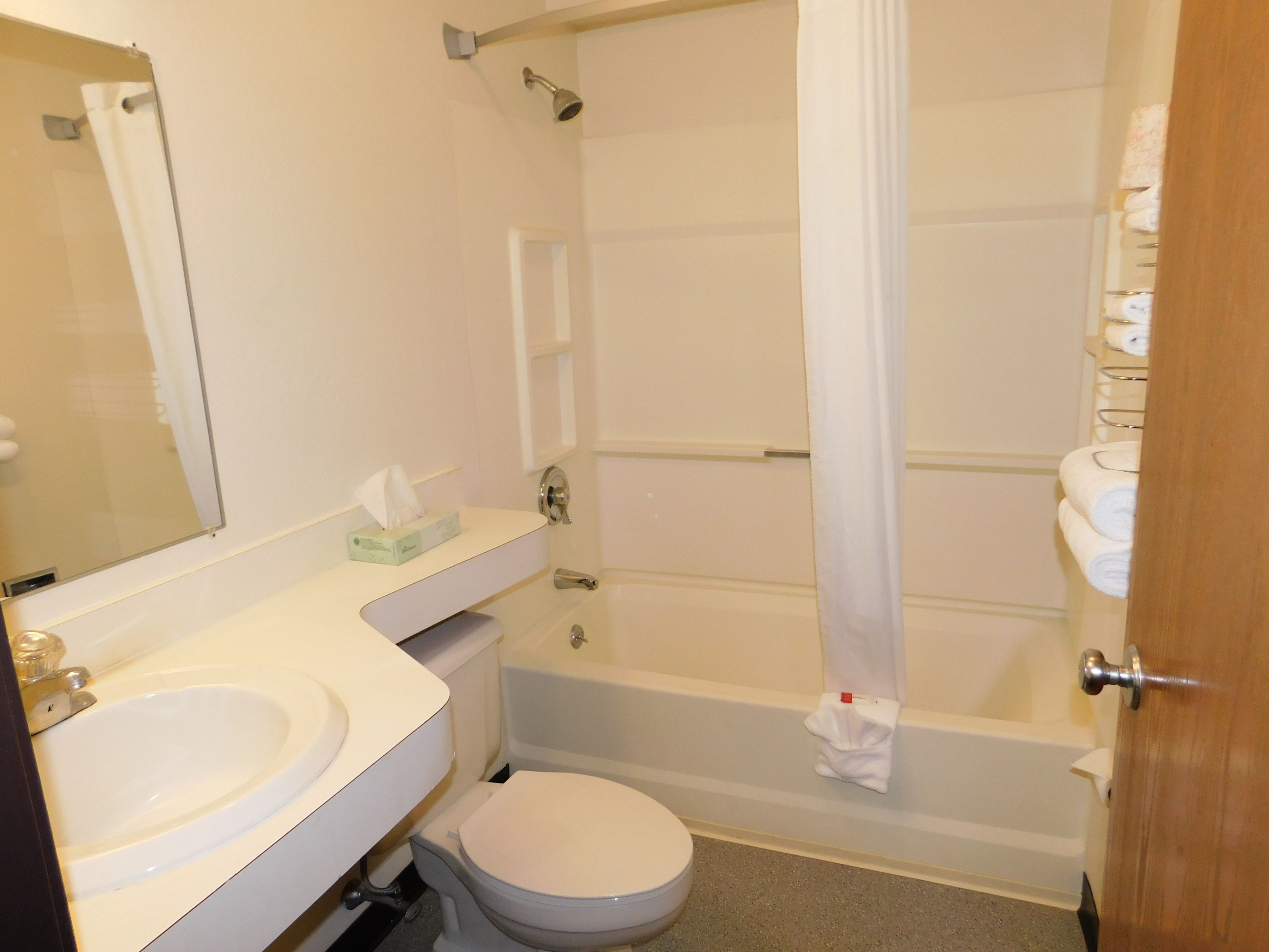 A bathroom with a sink, toilet, and bathtub.