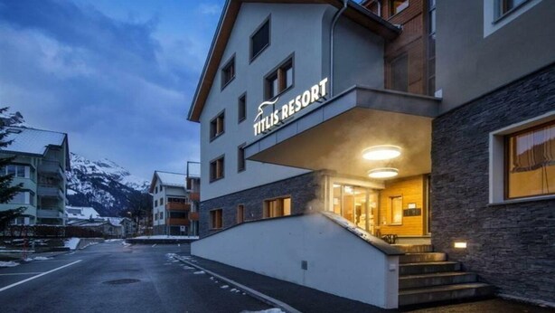 A modern hotel building with a sign reading "Titlis Resort." - Titlis Resort (Engelberg)